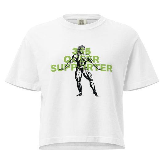 White boxy t-shirt, with the phrase ‘365 Queer Supporter’ in bold green lettering. Features a black illustration of a strong bodybuilder. Promotes year-round support for LGBTQ+ athletes and the belief that we should all be strong—together and as individuals. Designed by a queer-owned business.