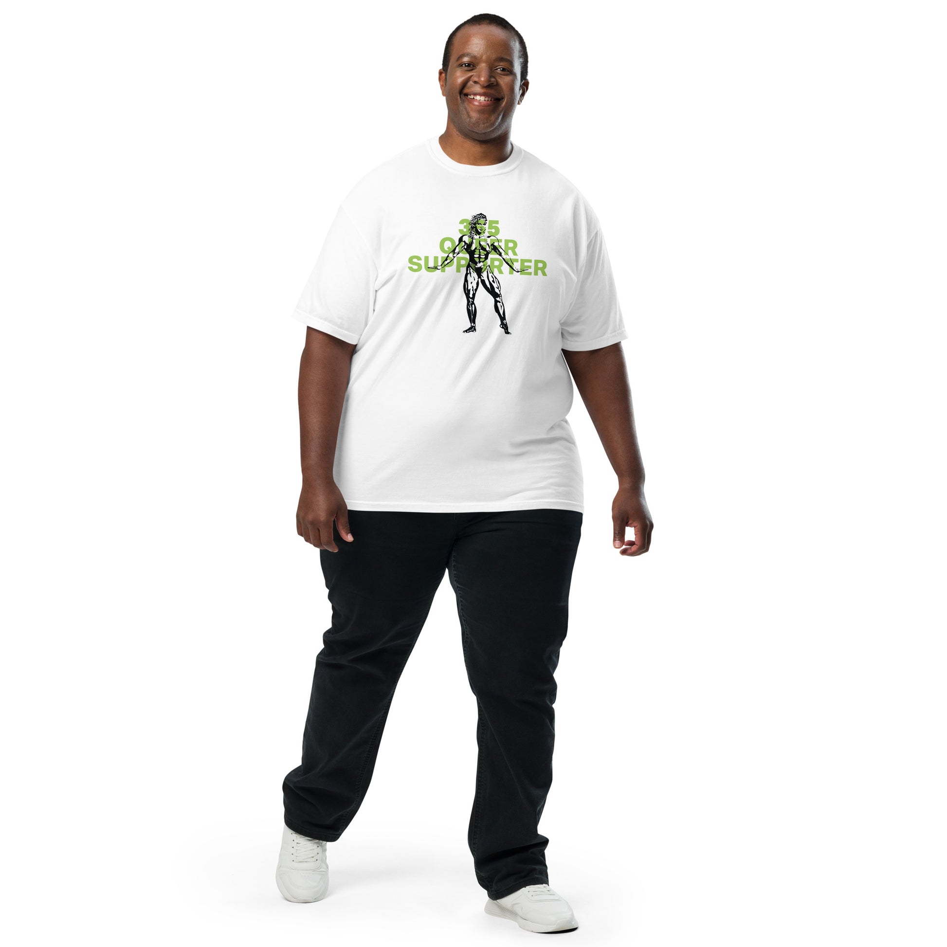 White t-shirt with the phrase ‘365 Queer Supporter’ in bold green lettering. Features a black illustration of a strong bodybuilder. Promotes year-round support for LGBTQ+ athletes and the belief that we should all be strong—together and as individuals. Designed by a queer-owned business. Shown on curvy model.