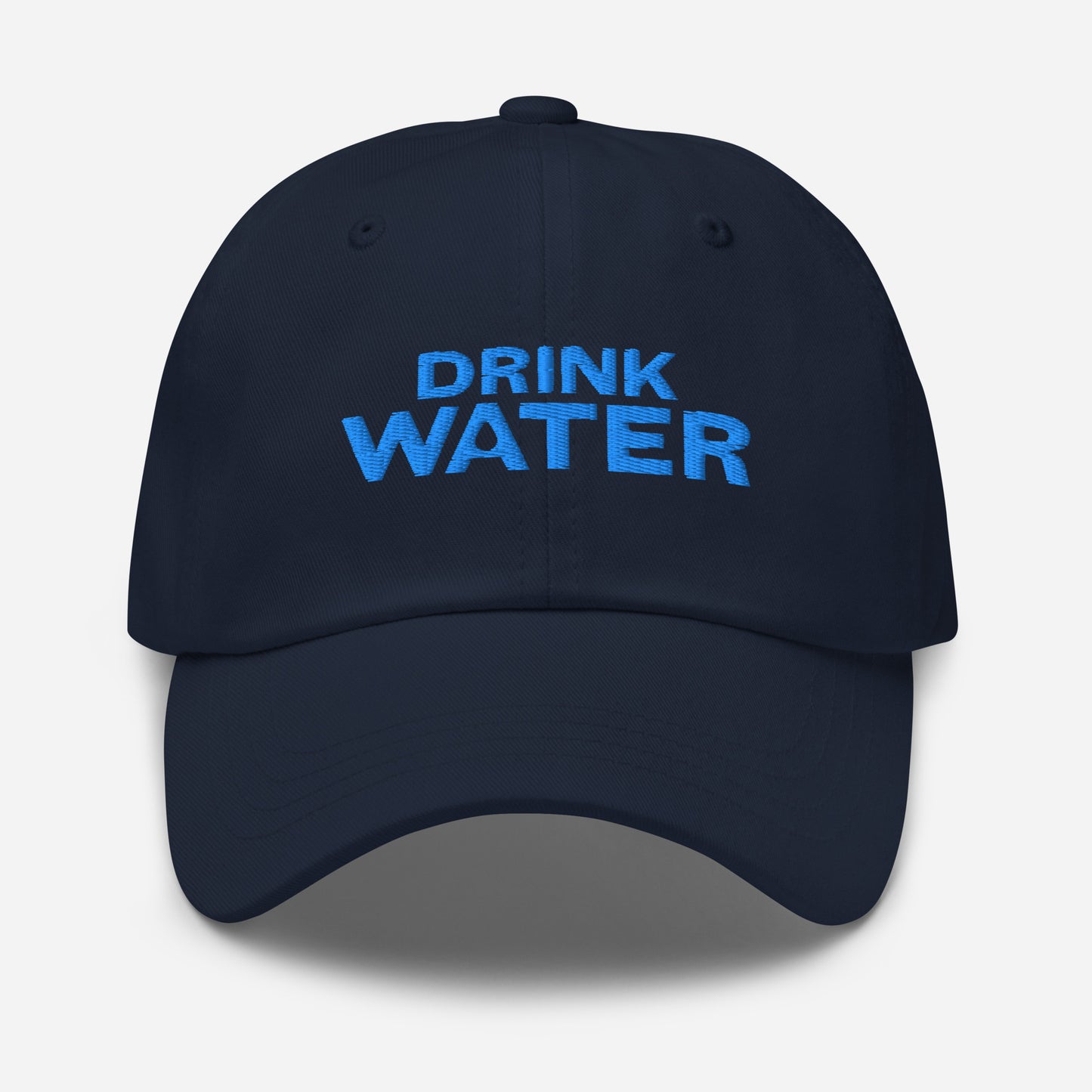 Navy classic dad hat with bright blue text that reads ‘DRINK WATER’ designed by queer creators to express the need to remember to stay hydrated. Front view, not on model.