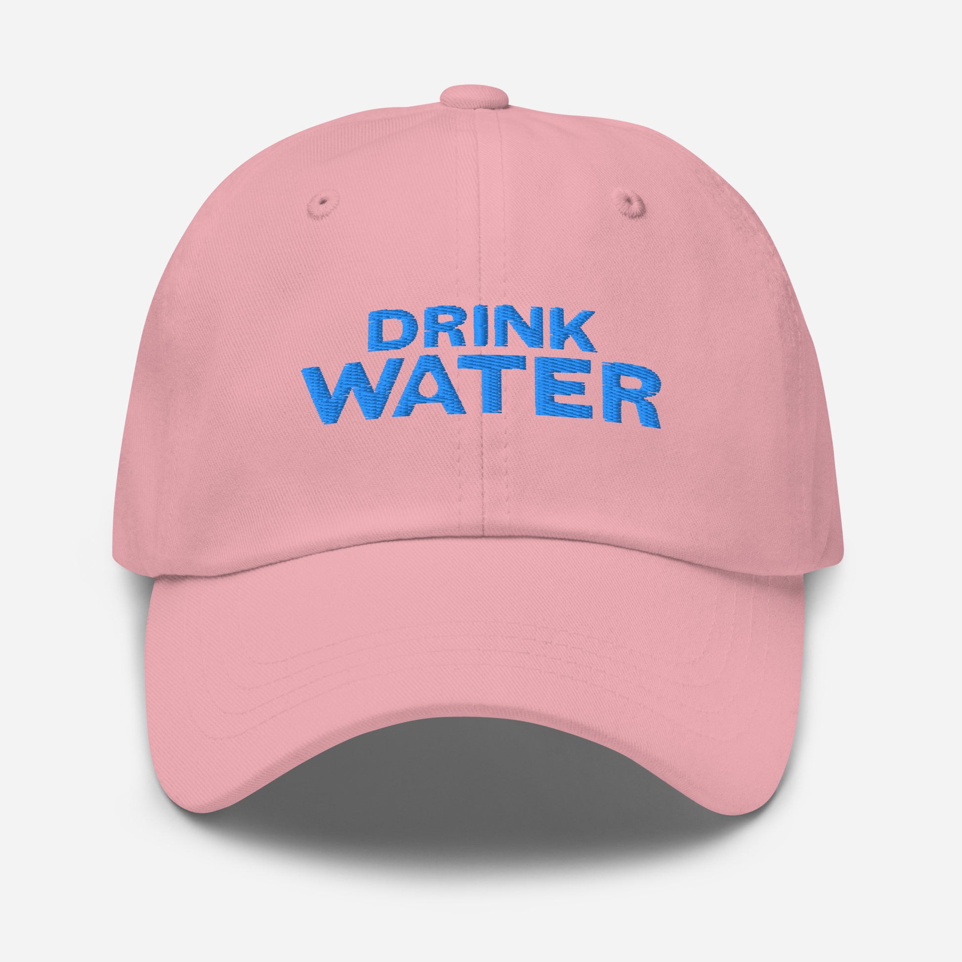 Pink classic dad hat with bright blue text that reads ‘DRINK WATER’ designed by queer creators to express the need to remember to stay hydrated. Front view, not on model.
