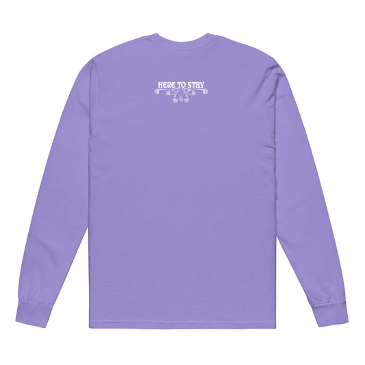 Violet, long-sleeve shirt. Featuring the phrase ‘Queer existence is the agenda’ on the front, ‘here to stay’ on the back. Design is in white, with a butterfly design on the front and an abstract design on the back. Design is in contrast to legislation that is based on eraser of queer people. Designed by a small LGBTQ+ owned business. Back of shirt.