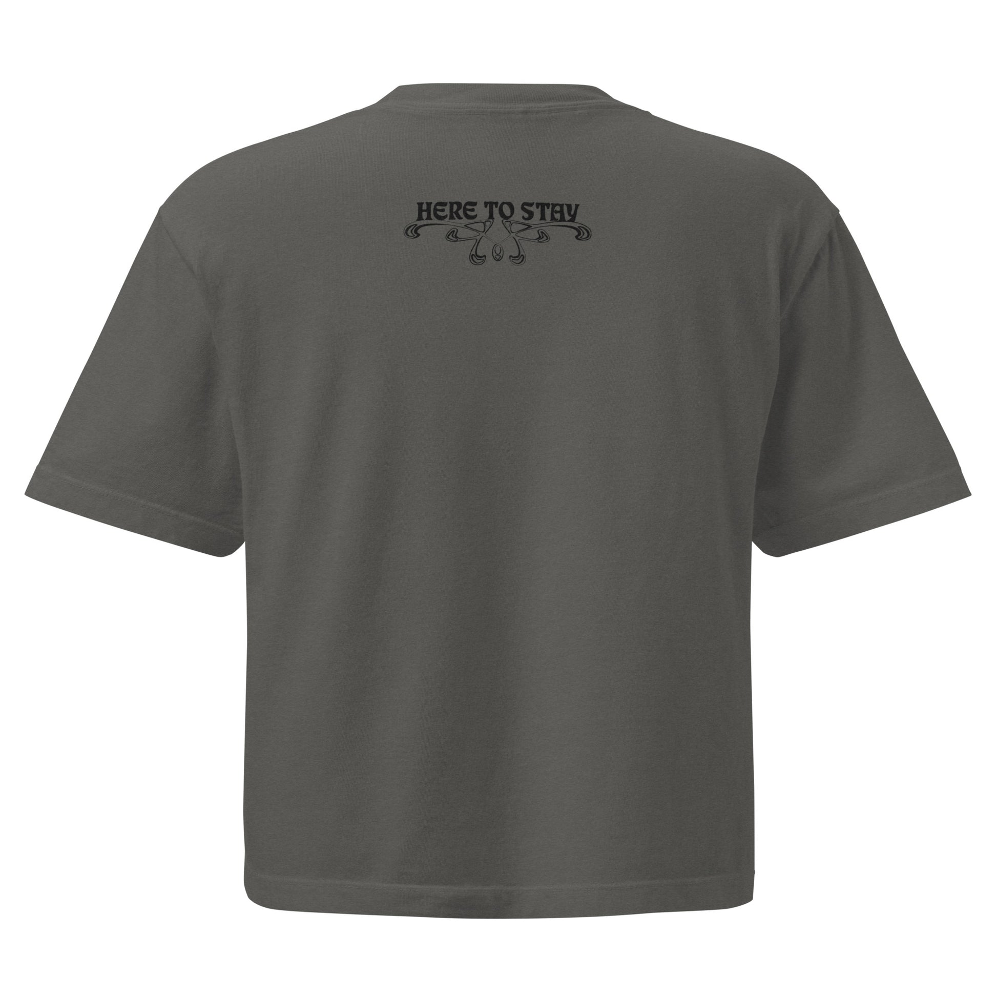 Pepper, boxy t-shirt. Featuring the phrase ‘Queer existence is the agenda’ on the front, ‘here to stay’ on the back. Design is in black, with a butterfly design on the front and an abstract design on the back. Design is in contrast to legislation that is based on eraser of queer people. Designed by a small LGBTQ+ owned business. Back of shirt. 