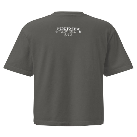 Pepper, boxy t-shirt. Featuring the phrase ‘Queer existence is the agenda’ on the front, ‘here to stay’ on the back. Design is in white, with a butterfly design on the front and an abstract design on the back. Design is in contrast to legislation that is based on eraser of queer people. Designed by a small LGBTQ+ owned business. Back of shirt. 