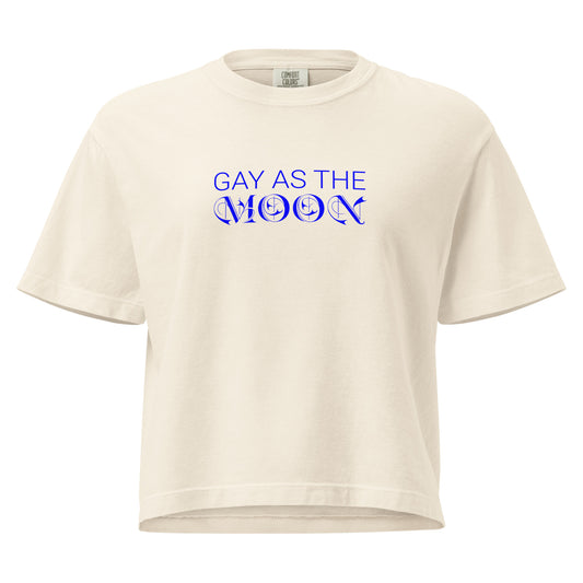 Ivory, boxy t-shirt featuring the phrase ‘Gay as the moon’ in a blue decorative typeface. Playful nod to queer identity and astrology, embracing the idea that the moon is gay. Designed by a small LGBTQ+ owned business. Front of shirt.