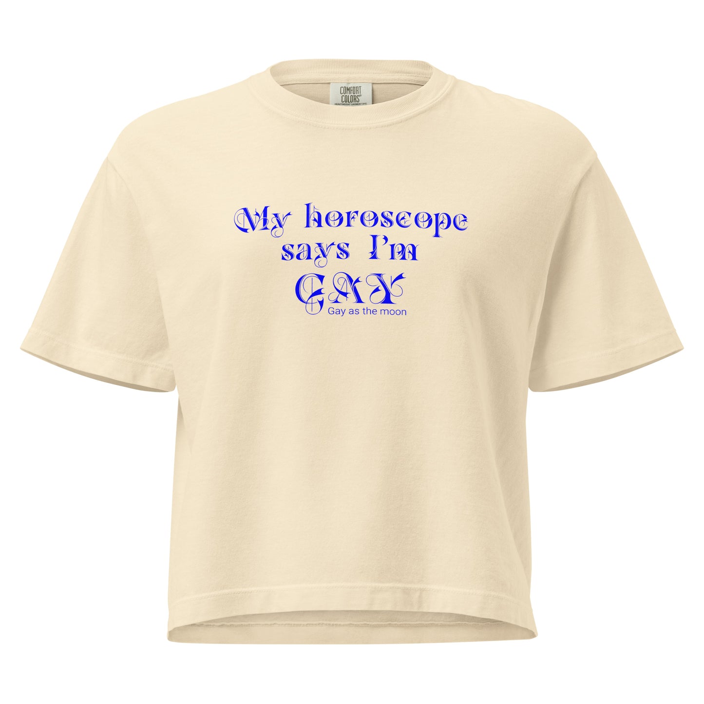 Ivory, boxy t-shirt featuring the phrase ‘My horoscope says I’m gay’ in a blue decorative typeface, gay as the moon. Playful nod to queer identity and astrology, embracing the idea that astrology is gay. Designed by a small LGBTQ+ owned business. Front of shirt.