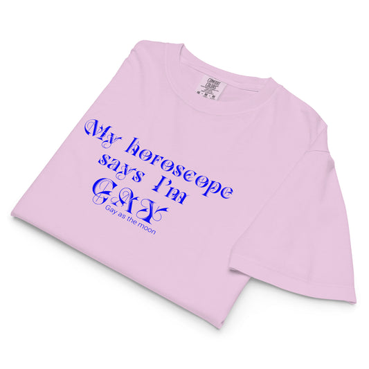 Orchid, boxy t-shirt featuring the phrase ‘My horoscope says I’m gay’ in a blue decorative typeface, gay as the moon. Playful nod to queer identity and astrology, embracing the idea that astrology is gay. Designed by a small LGBTQ+ owned business. Folded view of shirt.