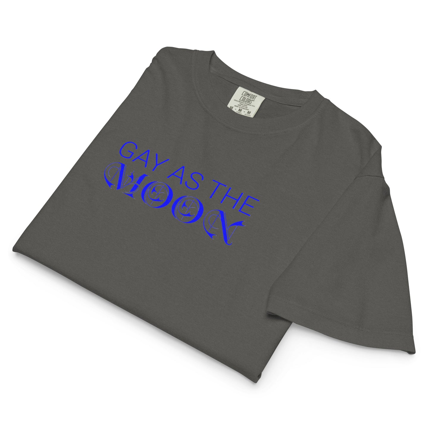 Pepper, boxy t-shirt featuring the phrase ‘Gay as the moon’ in a blue decorative typeface. Playful nod to queer identity and astrology, embracing the idea that the moon is gay. Designed by a small LGBTQ+ owned business. Folded view of shirt.