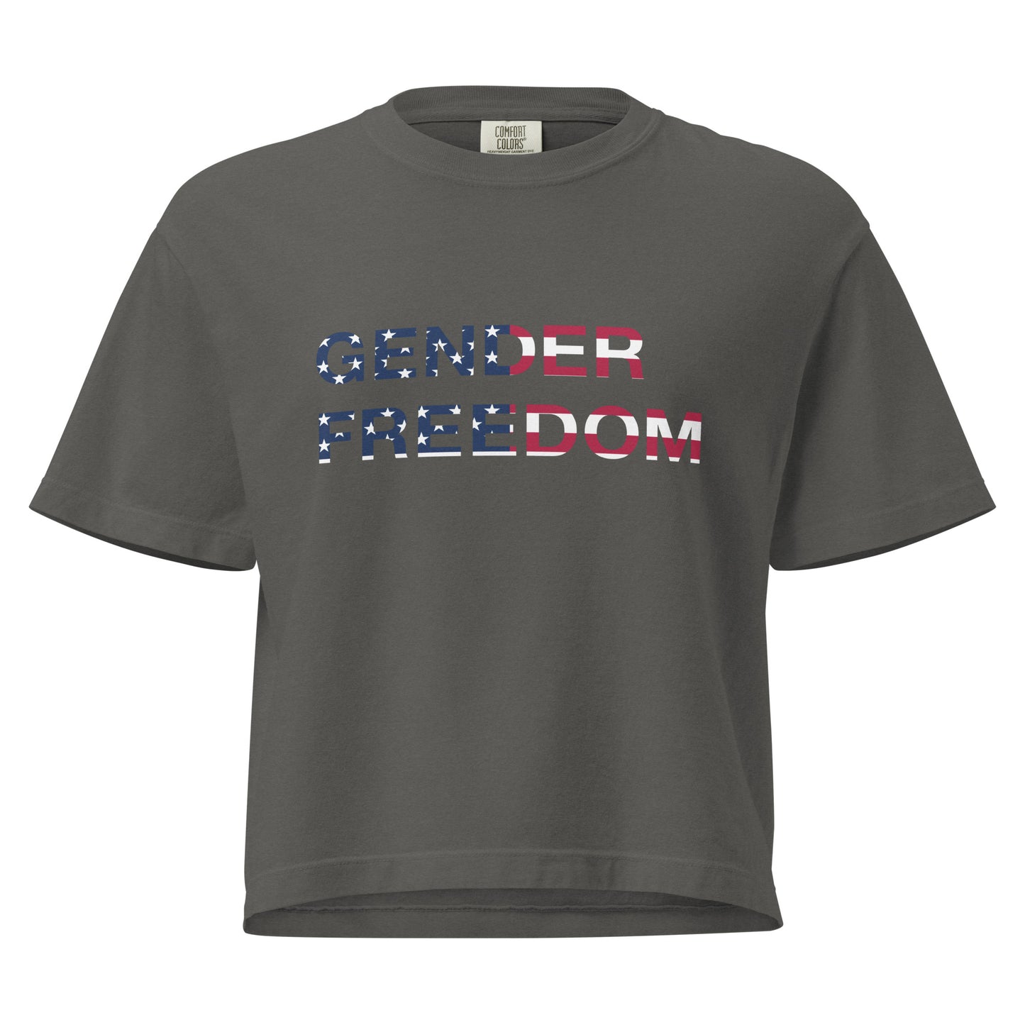 Pepper, boxy T-shirt featuring the phrase 'Gender Freedom’ over the American flag honoring the First Amendment and the patriotic right to express identity, speak truth, and live freely in the land of liberty. Designed by a small LGBTQ+ owned business. Front of shirt