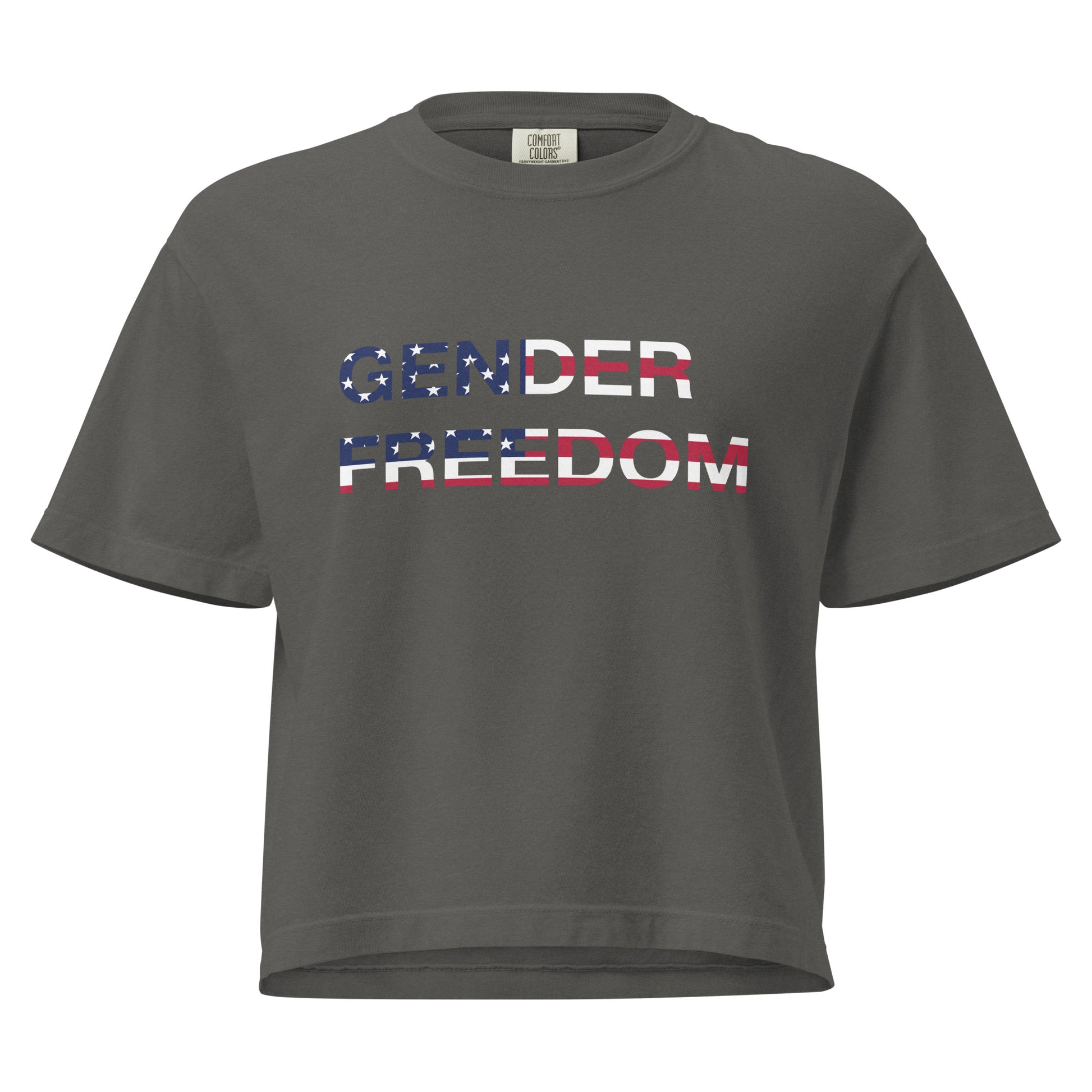 Pepper, boxy T-shirt featuring the phrase 'Gender Freedom’ over the American flag honoring the First Amendment and the patriotic right to express identity, speak truth, and live freely in the land of liberty. Designed by a small LGBTQ+ owned business. Front of shirt