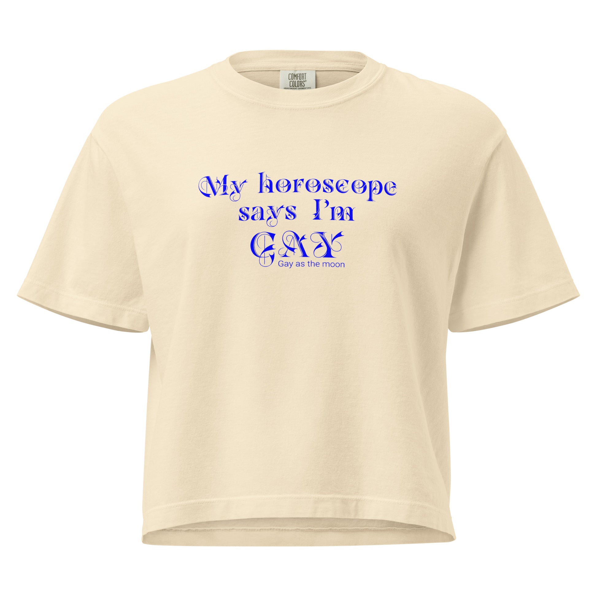 Ivory, boxy T-shirt featuring the phrase ‘My horoscope says I’m gay’ in a decorative blue typeface, gay as the moon. Playful nod to queer identity and astrology, embracing the idea that astrology is gay. Designed by a small LGBTQ+ owned business. Front of t-shirt.