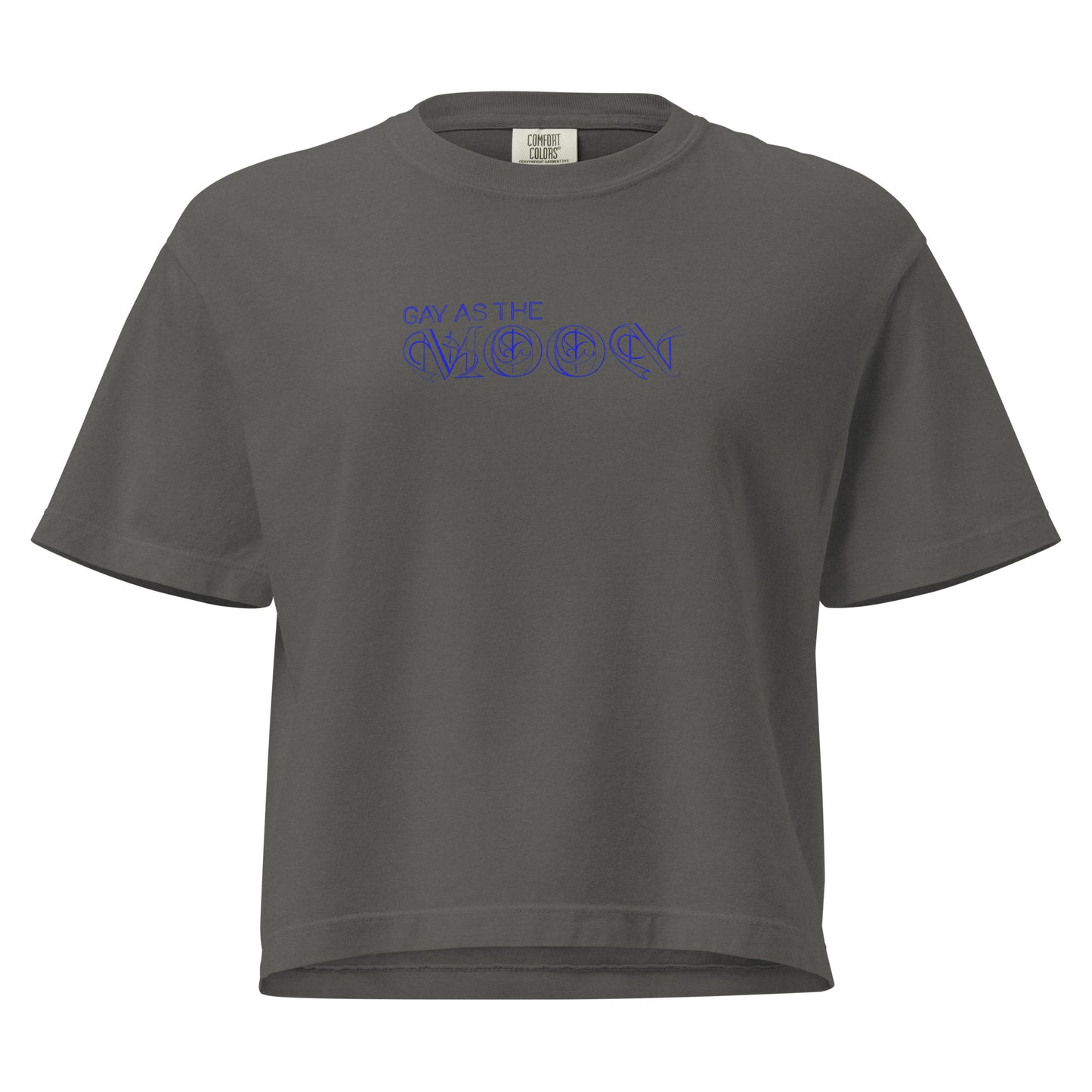 Pepper, boxy T-shirt featuring the phrase ‘Gay as the moon’ in a decorative blue typeface. Playful nod to queer identity and astrology, embracing the idea that astrology is gay. Designed by a small LGBTQ+ owned business. Front of t-shirt. 