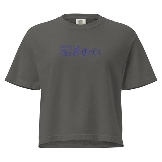 Pepper, boxy T-shirt featuring the phrase ‘Gay as the moon’ in a decorative blue typeface. Playful nod to queer identity and astrology, embracing the idea that astrology is gay. Designed by a small LGBTQ+ owned business. Front of t-shirt. 
