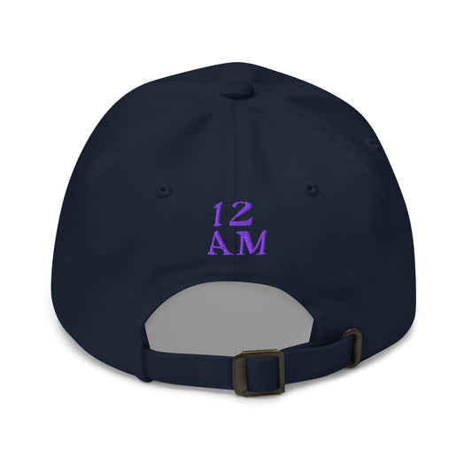 Navy blue hat, featuring the phrase ‘Gay as the moon’ in a decorative white typeface. Playful nod to queer identity and astrology, embracing the idea that astrology is gay. Designed by a small LGBTQ+ owned business. Back of hat with purple 12AM logo.  