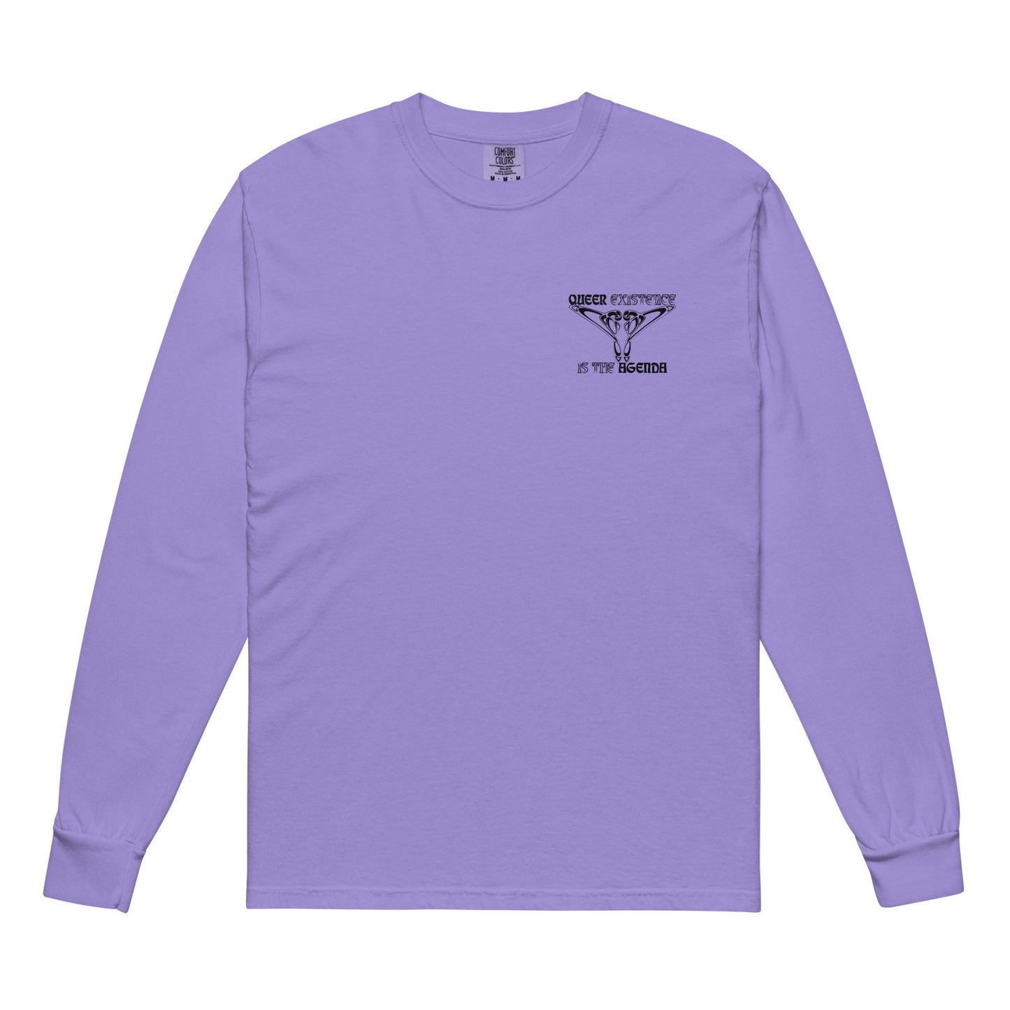 Violet, long-sleeve shirt. Featuring the phrase ‘Queer existence is the agenda’ on the front, ‘here to stay’ on the back. Design is in black, with a butterfly design on the front and an abstract design on the back. Design is in contrast to legislation that is based on eraser of queer people. Designed by a small LGBTQ+ owned business. Front of shirt. 