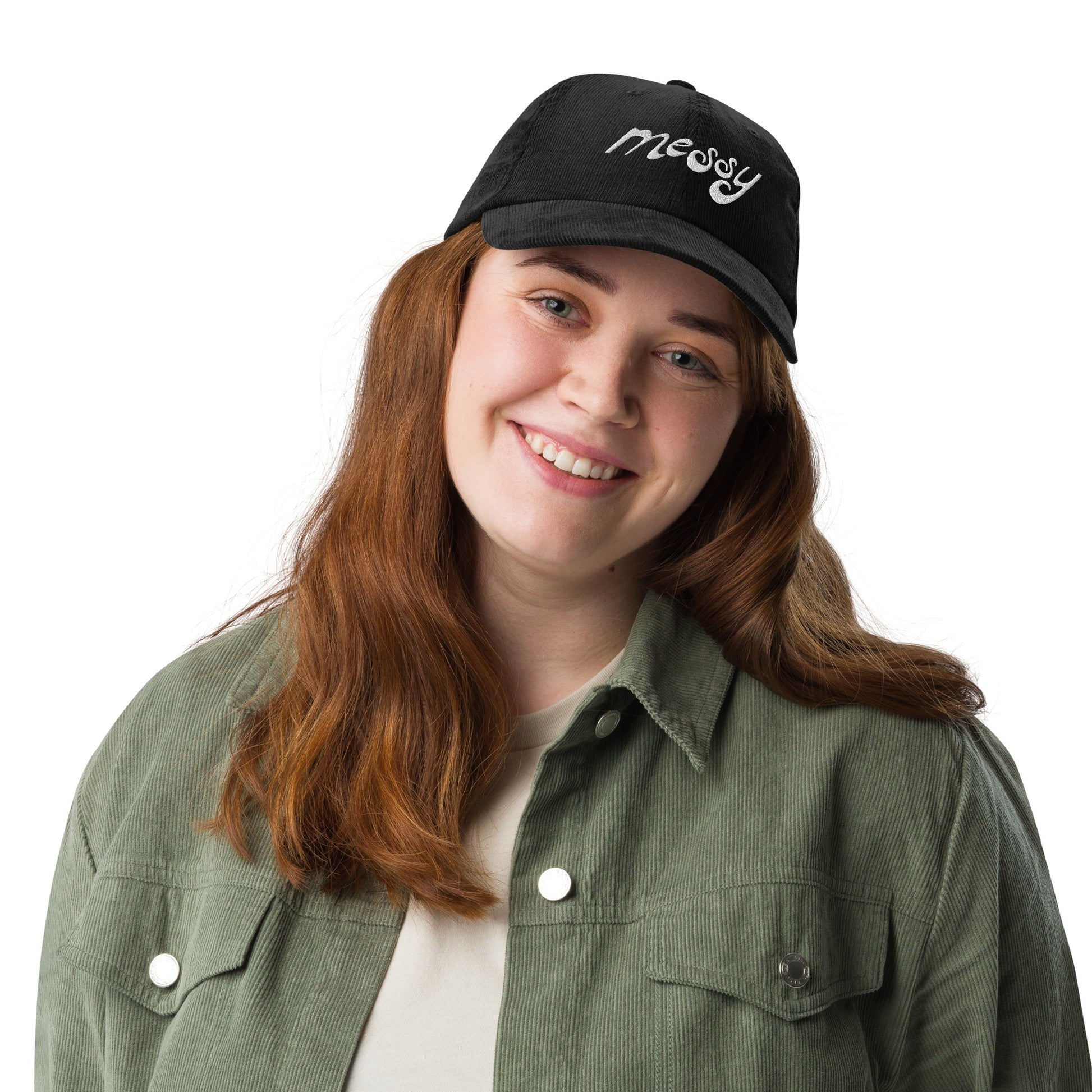 Black, vintage corduroy dad hat embroidered with "messy" in white stylized lettering — a 12:AM Intuition design for the beautifully complicated. On model.
