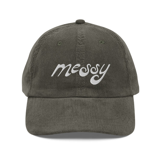 Vintage olive corduroy dad hat embroidered with "messy" in white stylized lettering — a 12:AM Intuition design for the beautifully complicated.