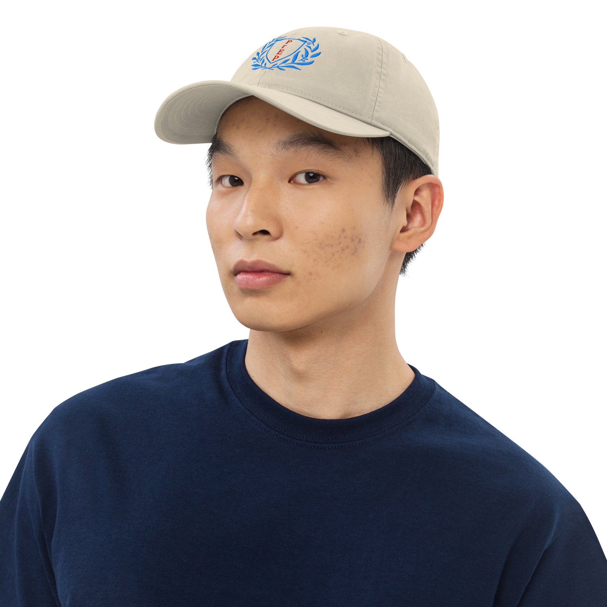 Oyster colored hat, front text reading ‘PrEP’ in red, blue leaves styled in Ivy League-inspired design. Made by queer creators to promote HIV awareness and access to PrEP through unapologetic activism and education. Front view, on model.